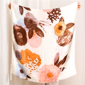 Detail of thin rectangular scarf with abstract ink painting floral pattern and raw edges