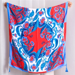 Detailed view of colorful exotic floral print scarf with elegant fringe and tassels