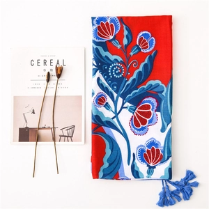 Bohemian floral cotton linen scarf with blue tassels shown with minimalist props