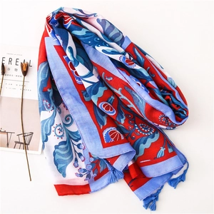 Elegant floral linen scarf with pomegranate print and blue tassels on white background