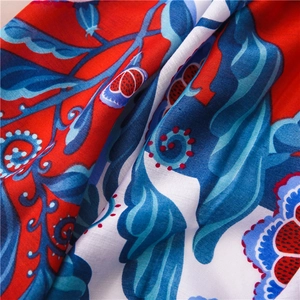 Detailed close-up of vibrant floral patterns and exotic ethnic weave on cotton linen scarf