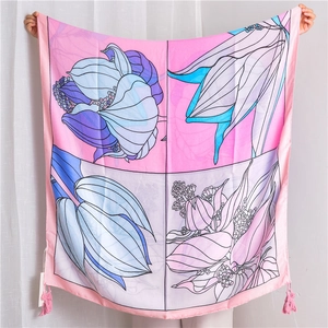 Detailed view of floral cotton linen shawl with pink tassels and colorful flower patterns