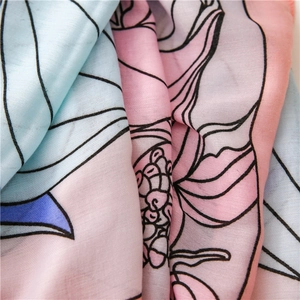 Close-up of pastel floral cotton-linen scarf with soft fabric texture and layered detail