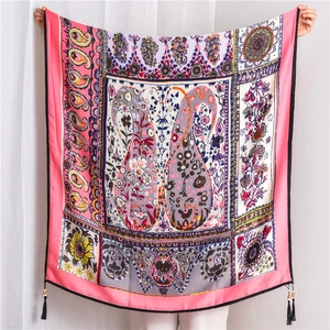 Detail of bohemian paisley linen scarf with floral print and beaded tassels