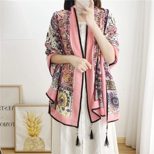 Close-up of pink paisley linen scarf with detailed black handmade fringe tassels