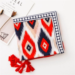 Close-up of geometric cotton linen scarf with red blue patterns and handmade tassels
