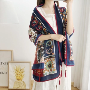 Detail of bohemian paisley linen scarf featuring handmade wooden beads and tassels