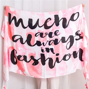 Detail of pink gradient cotton linen scarf with soft tassels and artistic text print