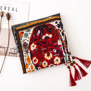Detail of bohemian cotton linen scarf with paisley print and wooden bead tassel fringe