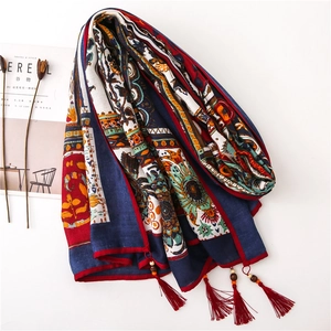 Close-up of bohemian paisley cotton linen scarf featuring handmade wood beads and tassels