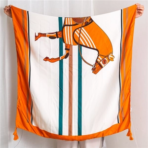 Detailed view of oversized orange equestrian print linen scarf with corner tassels