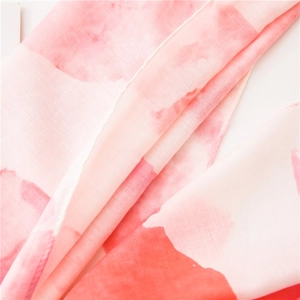 Pink watercolor print linen cotton scarf used as a lightweight beach sun protection shawl