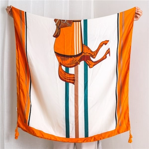Detail of vintage equestrian pattern silk scarf with horse saddle and fringe edges