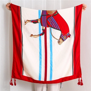 Detail of red and white cotton linen scarf with artistic horse pattern and red fringe