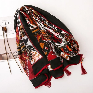 Detail of red and black paisley linen scarf with handmade wood bead tassels and fringe