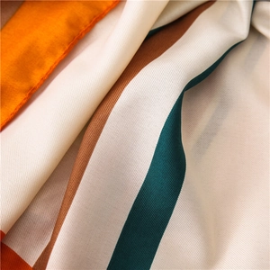 Detailed macro view showing the twill weave texture and stripes of the cotton linen scarf