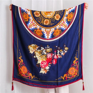 Detail of navy cotton linen shawl with peony pattern and red beaded corner tassels