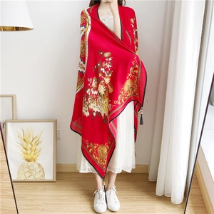 Detail of red floral cotton linen scarf with golden patterns and handmade wood bead tassels