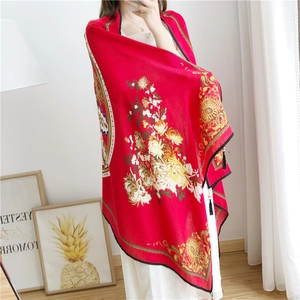 Close-up of red cotton linen shawl with peony floral print and black tassel fringe