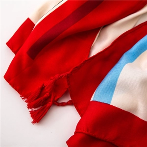 Close-up of red, white and blue striped cotton linen scarf with elegant tassel details