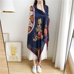 Detail of navy cotton linen scarf featuring floral prints and handmade wooden bead tassels