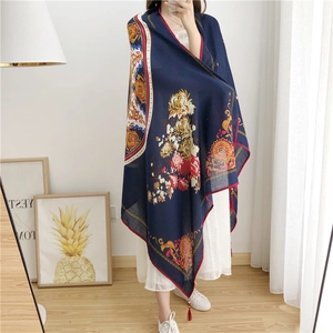 Detail of navy cotton linen scarf with floral print, vintage borders and red tassels