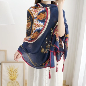 Detailed view of peony print cotton linen shawl with handmade wooden bead tassels
