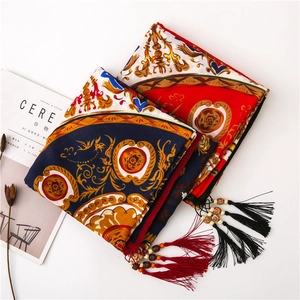 Close-up of cotton linen scarf featuring floral prints and handmade wooden bead tassels