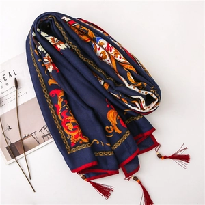 Detail of baroque peony pattern on blue linen scarf with wood bead and red tassels