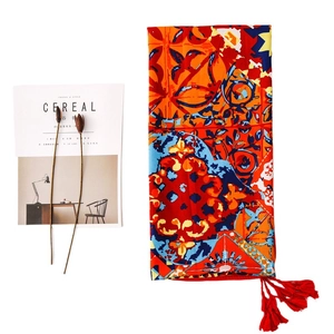 Ethnic print sun protection shawl with red tassels and orange-blue geometric patterns