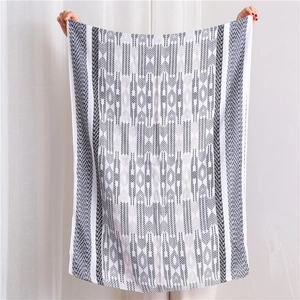 Close-up of cotton linen scarf with gray geometric jacquard pattern and soft texture