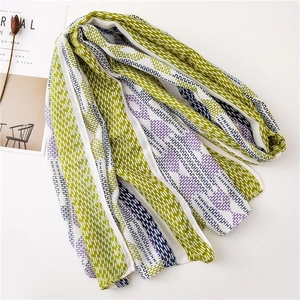 Detailed view of striped cotton-linen scarf with tassel fringe and geometric H pattern