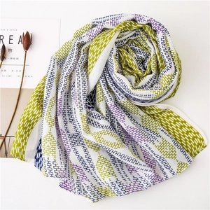 Detail of geometric tile pattern on light cotton-linen scarf with fringed edges