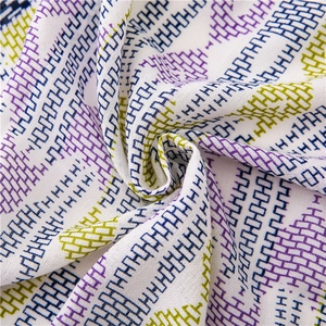 Macro detail of geometric purple and blue pattern on lightweight cotton-linen scarf fabric