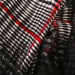 Close-up of classic black, white, and red gradient plaid fabric texture and woven pattern