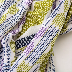 Close-up of vibrant geometric print and soft texture on this lightweight cotton linen scarf