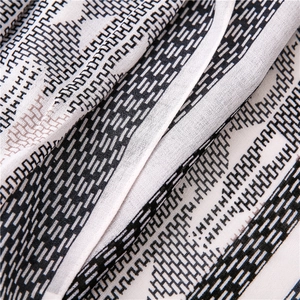 Macro shot showing modern black and white geometric pattern and cotton-linen textile texture