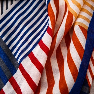 Macro detail of breathable fabric texture with red and blue geometric stripe patterns