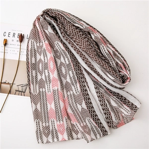 Close-up of geometric pattern scarf with cotton linen texture and fringe detail