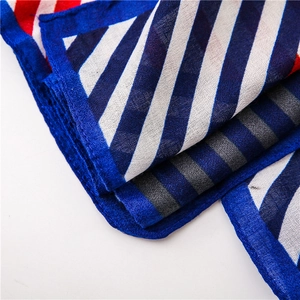 Detailed close-up showing the blue and red striped fabric texture and stitched hem of the scarf