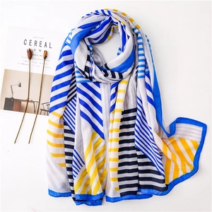 Red and blue geometric pattern long scarf with cotton-linen feel shown on flat lay