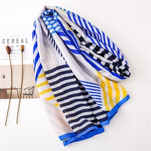 Detail of color-block striped scarf with neat blue stitching and a lifestyle layout