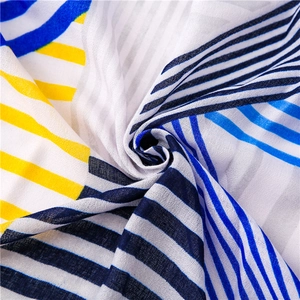Macro view of blue and yellow geometric striped fabric showing soft texture and drape