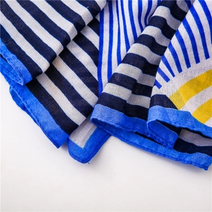 Close-up of lightweight geometric printed scarf with blue and yellow stripes and fine hem