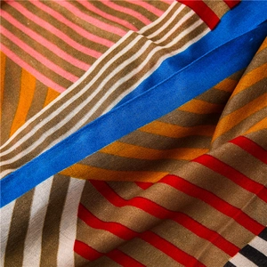Detail of colorful geometric striped scarf with soft texture and vibrant contrast colors