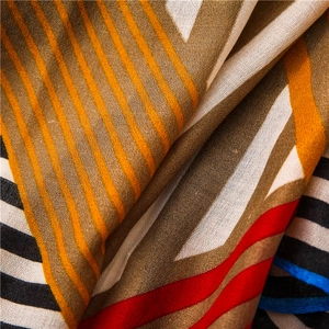Macro view of geometric printed scarf with vibrant red, blue and yellow color patterns