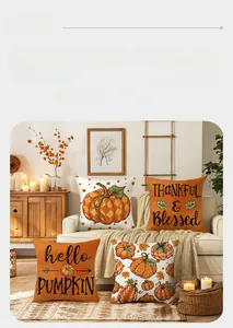 Detail of four fall harvest pumpkin and maple leaf printed pillow covers on a wooden couch
