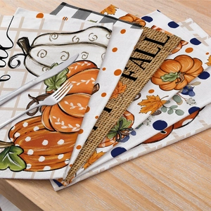Autumn linen placemats with harvest pumpkin and maple leaf prints for Thanksgiving decor
