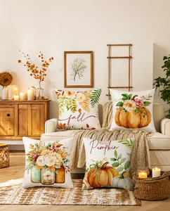Cozy autumn setting with pumpkin and maple leaf printed throw pillows on a sofa