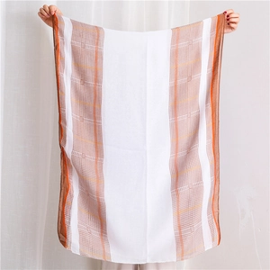 Detail of lightweight houndstooth scarf showing semi-transparent fabric and orange stripes